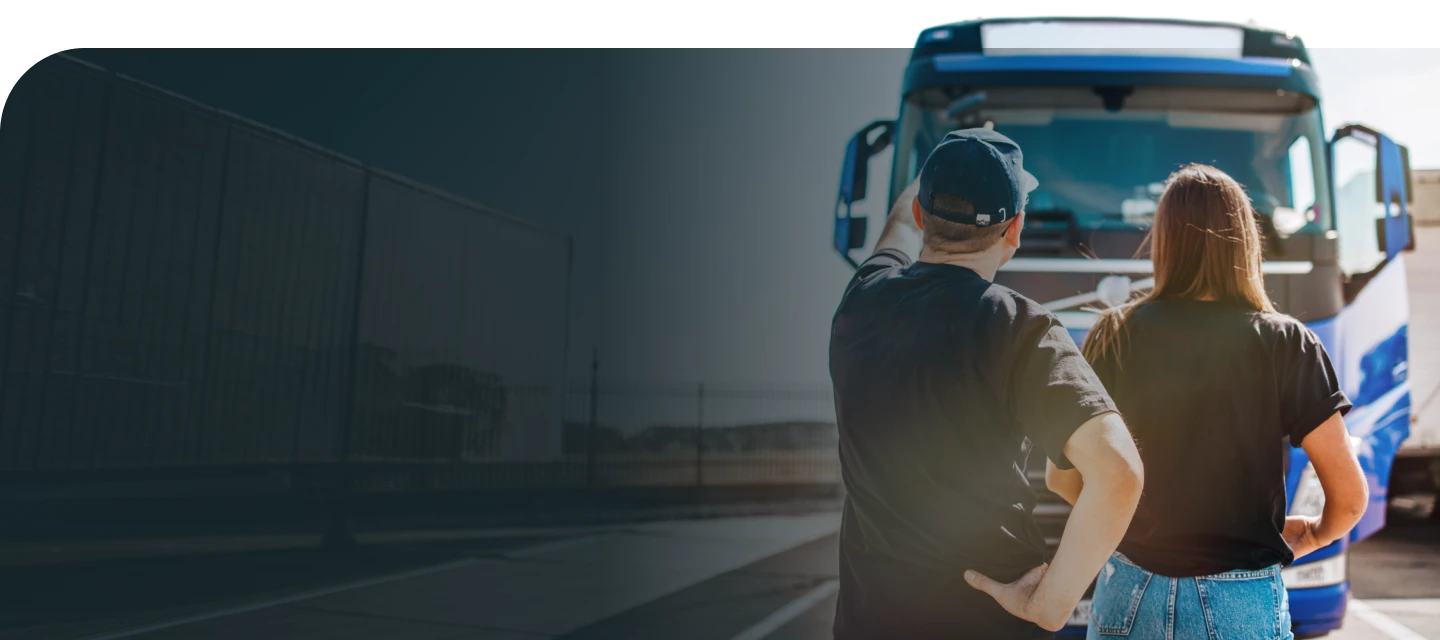 Drivers beside a transport vehicle